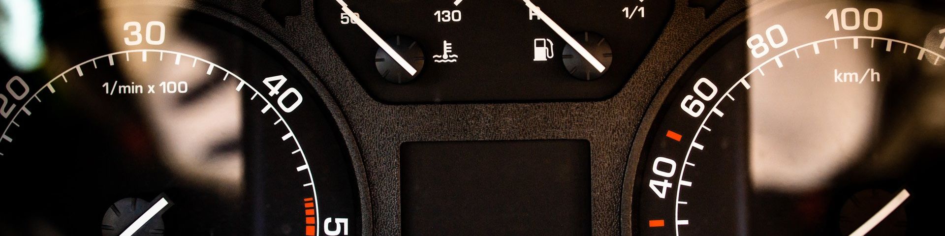 A close up of the tops of the left and right speedometers in a car. The fuel gauge is partially cut off.